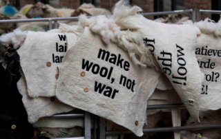 Embroidered felted wool blankets with statements for the wool march brussels
