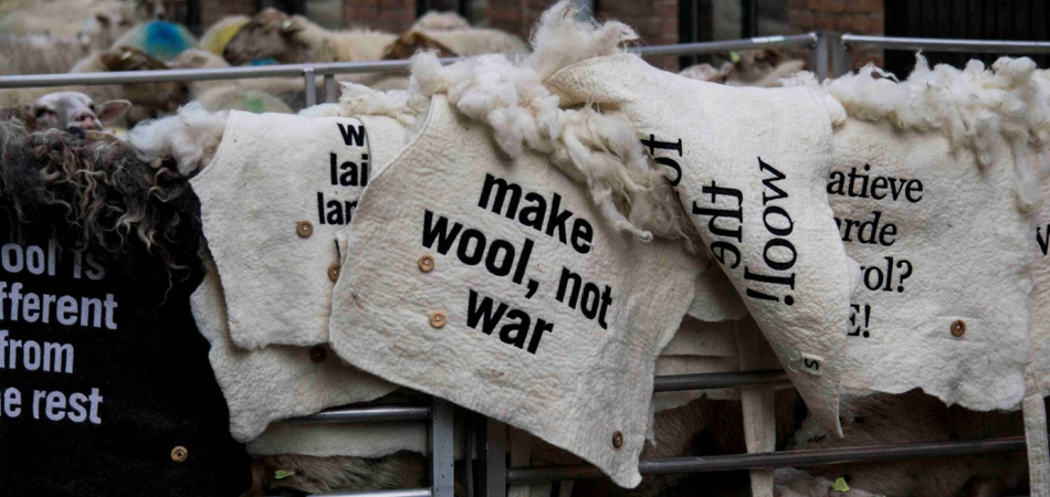 Embroidered felted wool blankets with statements for the wool march brussels