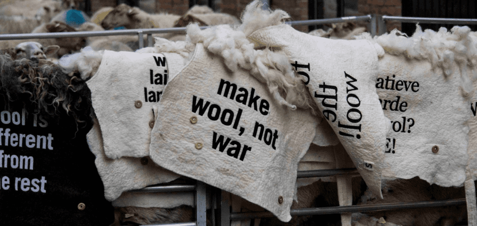 Felted wool blankets embroidered with statements for the wool march brussels